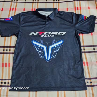 Dark NTORQ Club polo laid flat with blue chest graphics